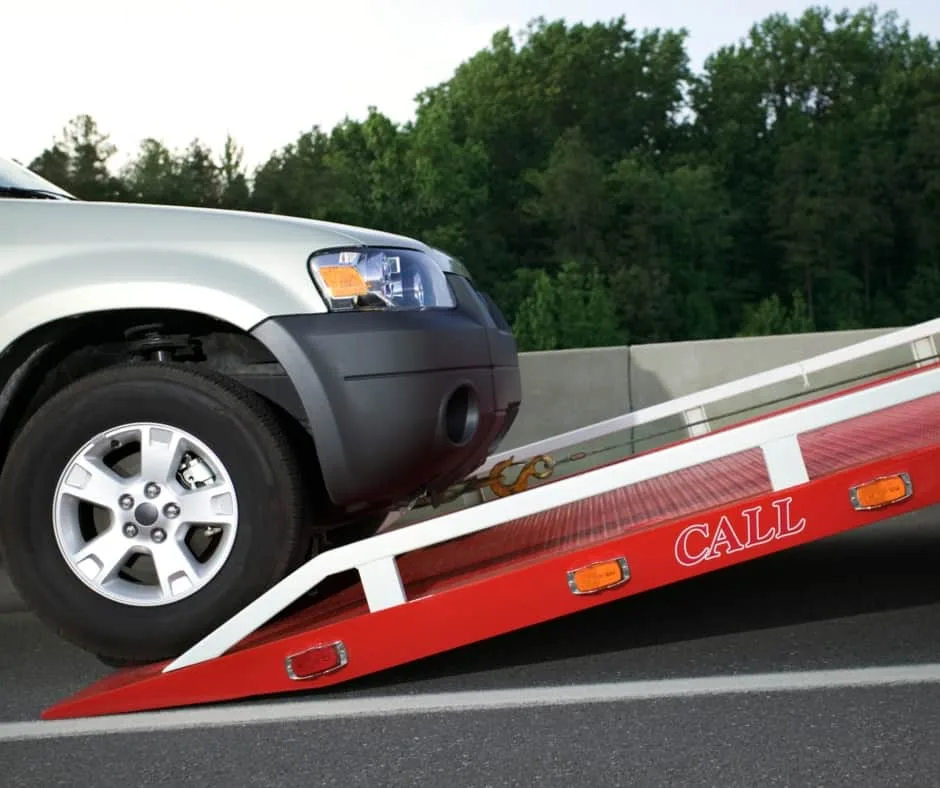 Philadelphia tow truck loading a vehicle on a residential street
