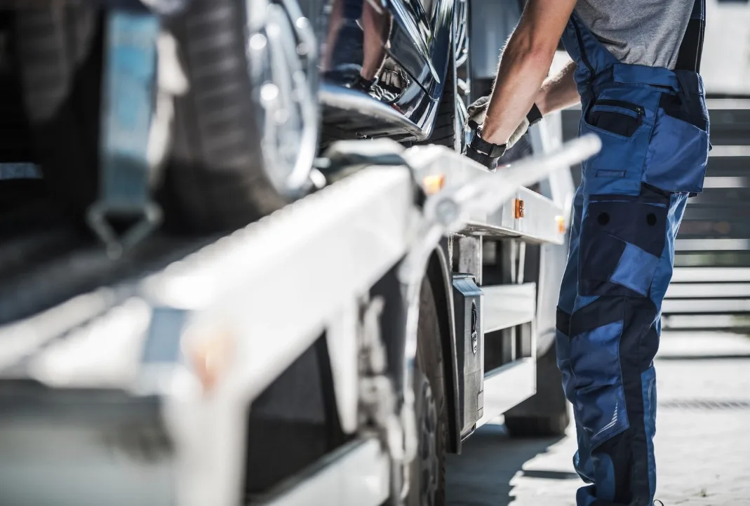 Philadelphia tow truck driver loading a car onto a flatbed